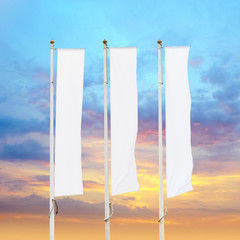 Three blank white corporate flags on flagpoles with sunset sky background, corporate flag mockup to ad logo, text or symbol, company identity flag template with copy space