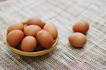 Fresh brown eggs in the basket, Pile of raw chicken egg
