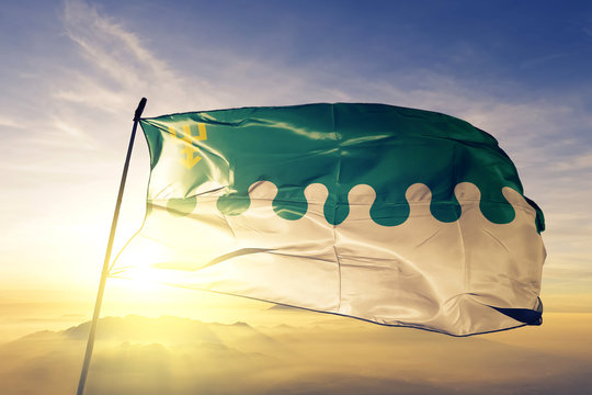 Edinet district of Moldova flag waving on the top sunrise mist fog