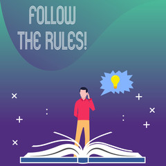 Writing note showing Follow The Rules. Business concept for go with regulations governing conduct or procedure Man Standing Behind Open Book Jagged Speech Bubble with Bulb