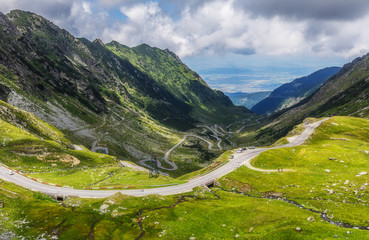 perfect sunny landscape. Fantastic mountain valley. View on beautiful mountain road at sunrise in summer.  Highway in european mountains. Europe,Romania. Transfagasan road.