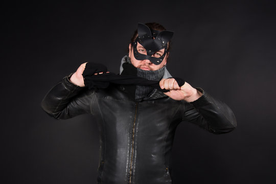 Adult games. The man in the mask. Black background.