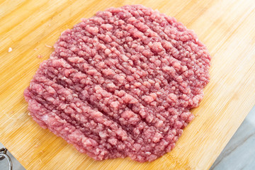 Minced pork puree on bamboo cutting board