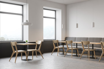 Corner of modern restaurant, sofa and chairs