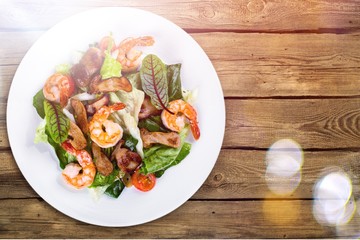 Green salad with shrimps on background
