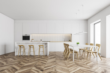White kitchen with bar and dining table
