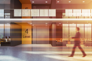 Man walking in office with elevator