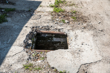 Dangerous opened manhole hole cover, danger for people who walking on the street in the city 