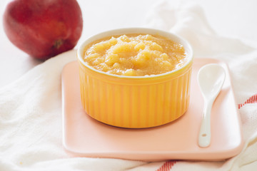Natural baby food concept. Bowl of apple baby puree.