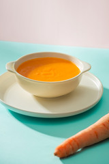 Carrot baby puree in bowl isolated on light background