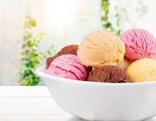 Ice cream scoops in bowl on white background