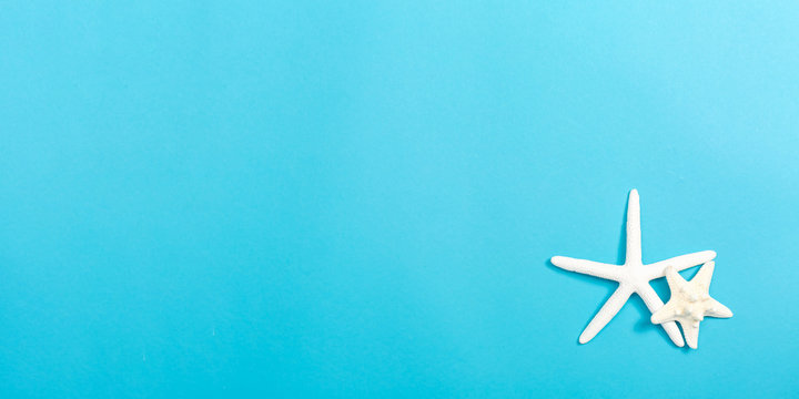 A Starfish On A Blue Paper Background