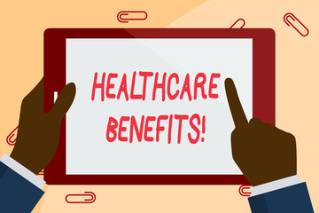 Writing note showing Healthcare Benefits. Business concept for monthly fair market valueprovided to Employee dependents Businessman Hand Holding and Pointing Colorful Tablet Screen