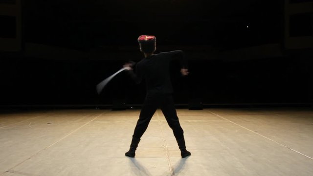 Guy dancing with swords