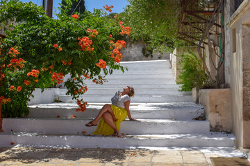 Young woman walking under oleanders in Kefalonia Island, Greece