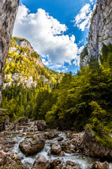 wonderful sunny mountain scenery. river in canyon in mountans gloving in sunlight. gorgeus unusual scene. Roman, Carpathian Mountains. Bicaz Canyon Cheile Bicazului . Beauty in the world.