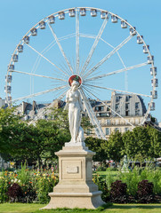 The statue of the Nymph against the backdrop of the Ferris wheel in the Louvre. Paris. France. August 2, 2018.