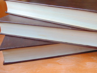 Old stacked books brown color. Vintage and antique.