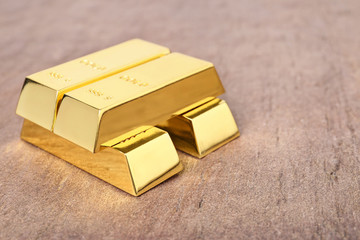 Shiny gold bars on table. Space for text