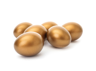 Many shiny golden eggs on white background