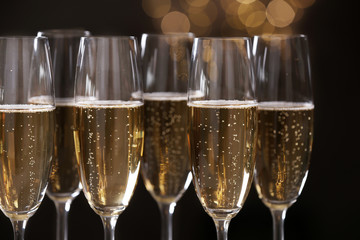 Many glasses of champagne on blurred background, closeup