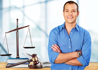 Man with glasses folded his arms and book, hammer and libra