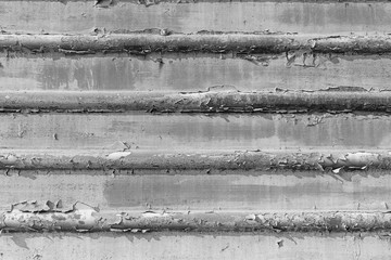Black and white gray old cracked rusty damaged painted metal background texture close-up