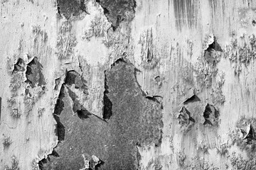 Black and white gray old cracked rusty damaged painted metal background texture close-up