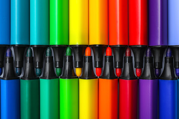 Many colorful markers as background, top view. Rainbow palette
