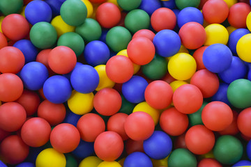 Fototapeta na wymiar Ball color for child. Many colorful plastic balls. Child room. Colored plastic toy balls of different color for the children's pool dry. View from afar. Picture background, wallpaper, texture.