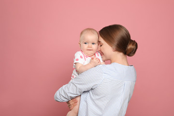 Happy mother with her baby on color background. Space for text