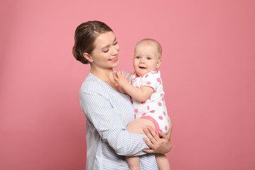 Portrait of happy mother with her baby on color background