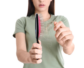 Young woman with brush on white background, closeup. Hair loss problem