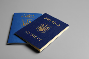 Ukrainian passports on grey background. International relationships