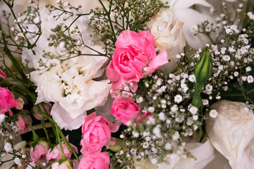 Pink and white roses in wedding bouquet.