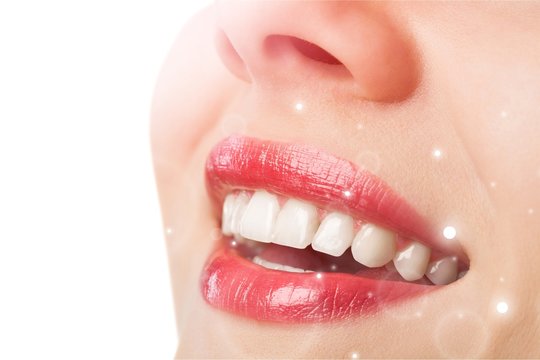 Beautiful wide smile of young fresh woman with great healthy white teeth. Isolated over white background