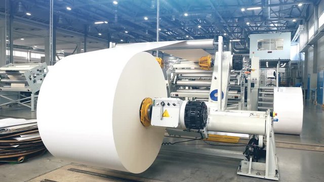 Large craft paper in printing house. Modern machine.