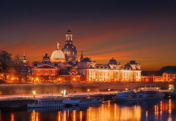 Fantastic colorful sunset in Dresden with dramatic sky, over the Elbe river. Old Town glowing in lighten reflected in the calm water. Picturesque unusual scene. Creative image. Dresden panorama