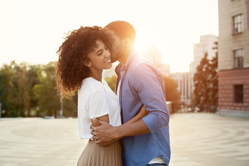 African-american boyfriend whispering words of love to girlfriend - Powered by Adobe
