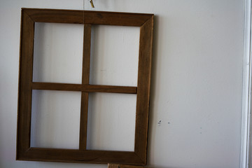 vintage window frame without glass on old white wall