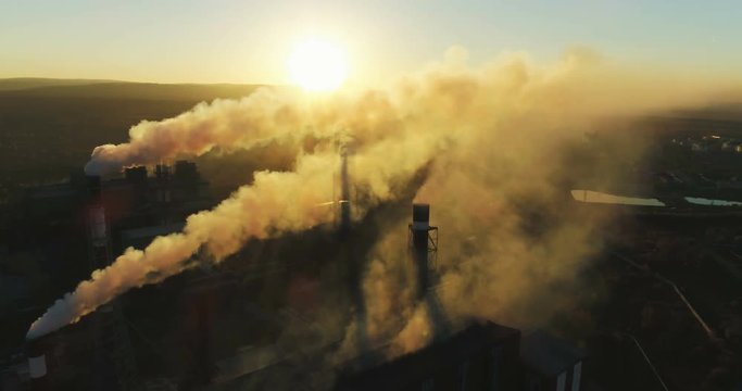 Top view of heavy industry plant smoking smokestacks at sunset Environmental pollution. Steel factory Aerial 4K
