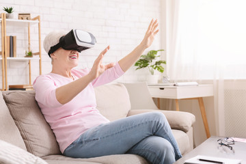 Senior woman with 3d glasses playing videogame at home