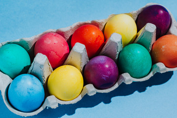 Easter background with Easter eggs. Top view with copy space. multicolored Easter eggs on a blue background