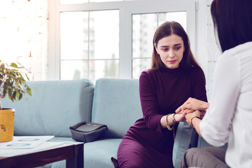 Crying lady being comforted during a visit to a psychologist