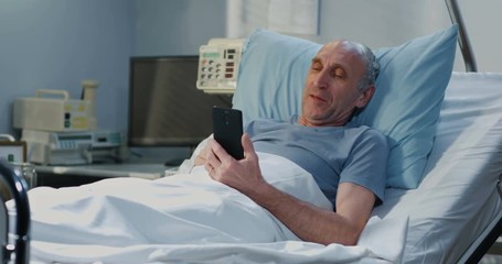 Male patient using video call in hospital room
