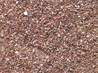 Sand and gravel on a seashore as nature background.