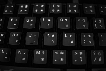 Black old dusty Thai English keyboard, selective focus