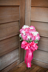 pink and white bridal bouquet with wooden background