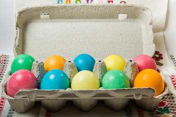 closeup set of dyed easter eggs served in cardboard box