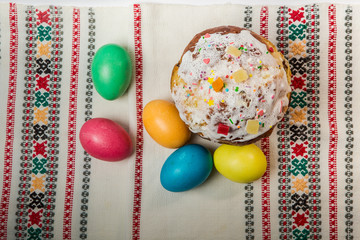 top view of decorated easter bread and dyed easter eggs